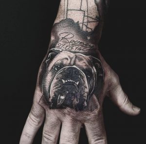 Black and white bulldog hand tattoo on man