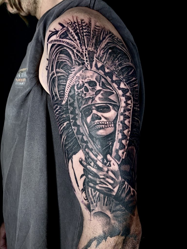 Black and white native American arm tattoo on male
