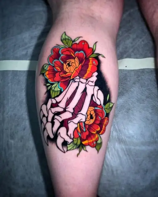 Skeleton and flower neotraditional leg tattoo