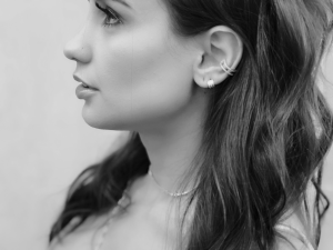 Black and white side view portrait of woman with earring curation